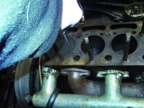 Dipping the water jacket for evidence of sludge