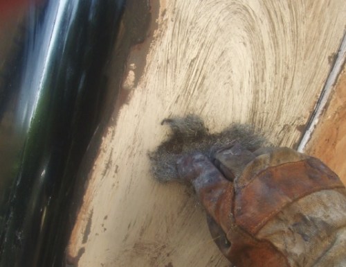 Using wire wool soaked with paint stripper, remove the stubborn spots.